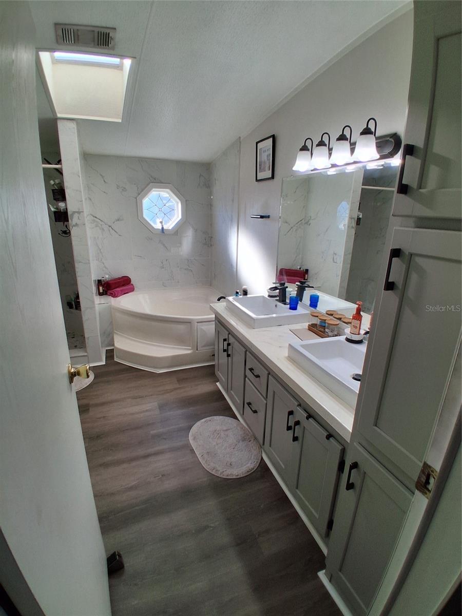 Private primary bathroom shows the recent updates.  Loads of cabinets.