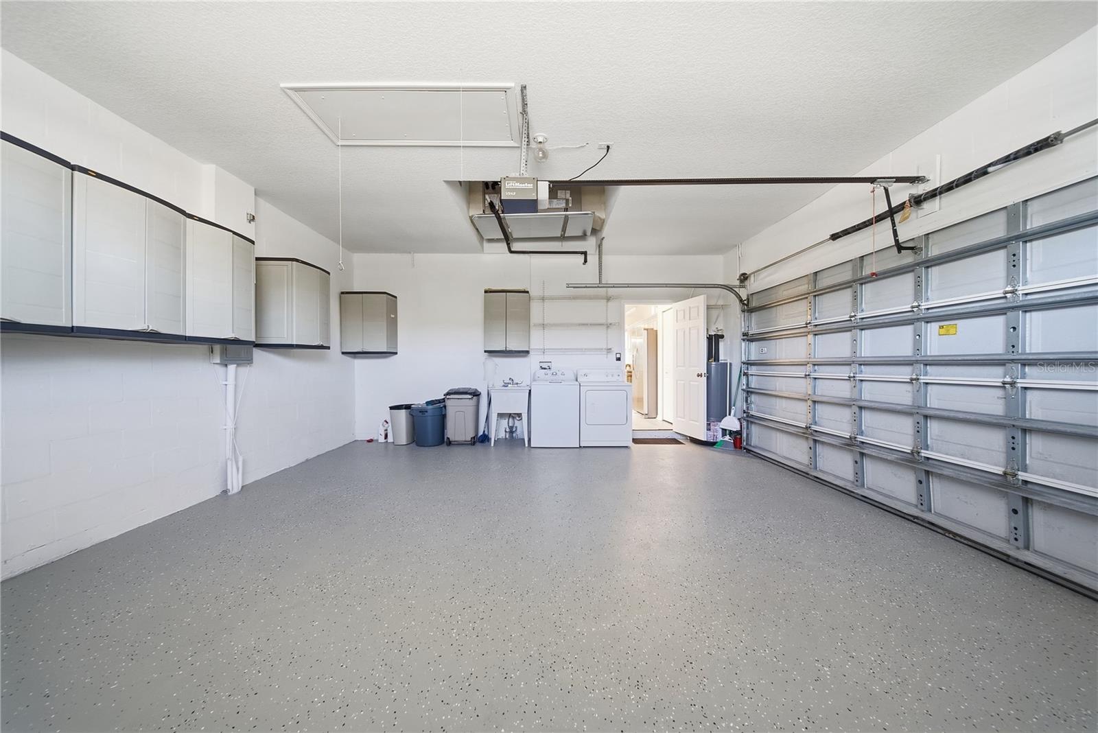 Large 2 car garage with cabinets for storage and has just had the floor painted/epoxy