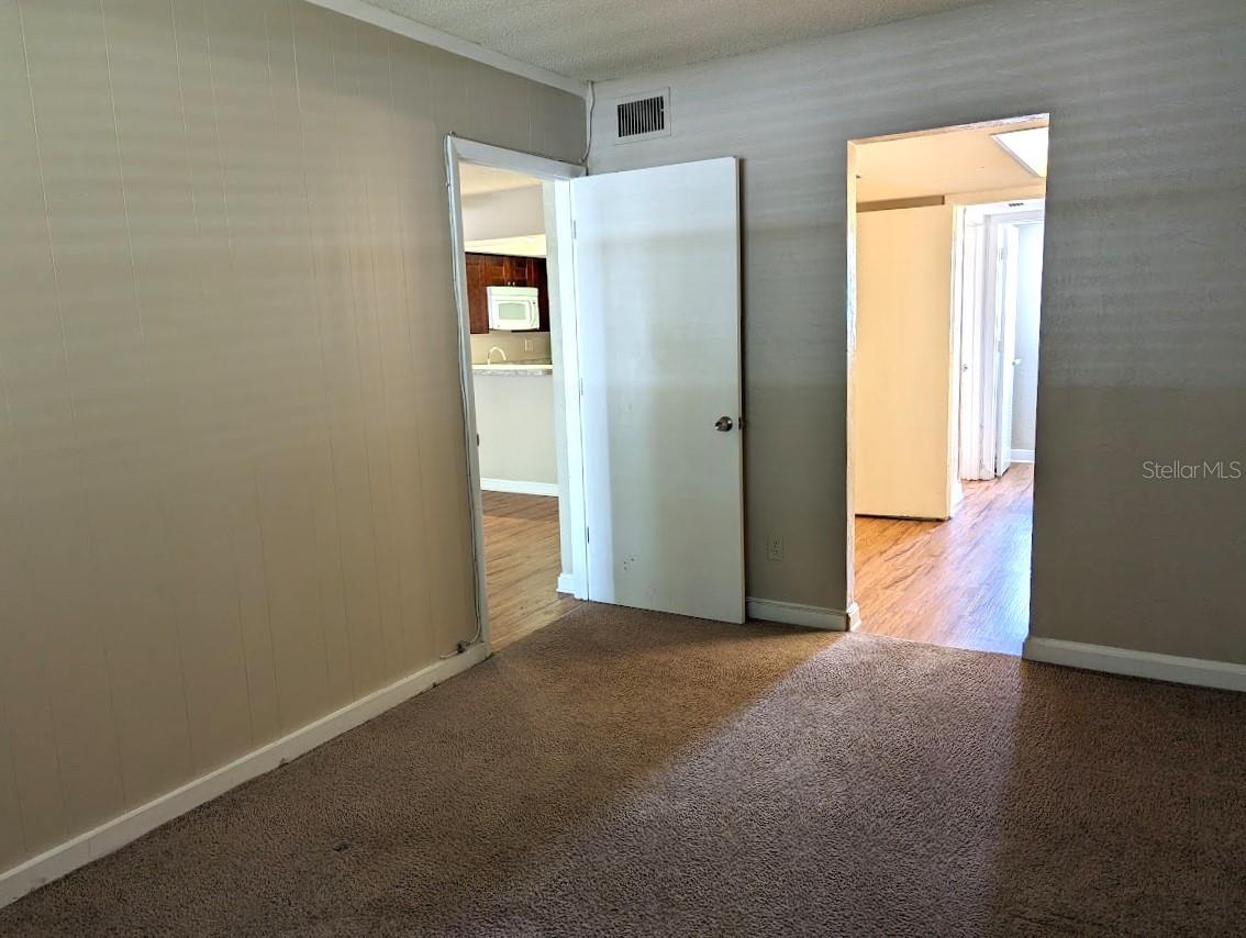 Bedroom with doors to living room and en suite bathroom