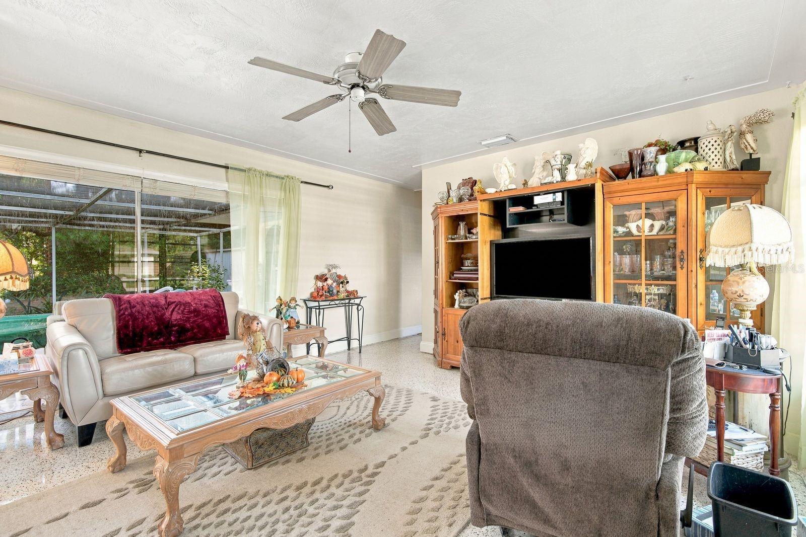 Family room with ample natural light with pool view
