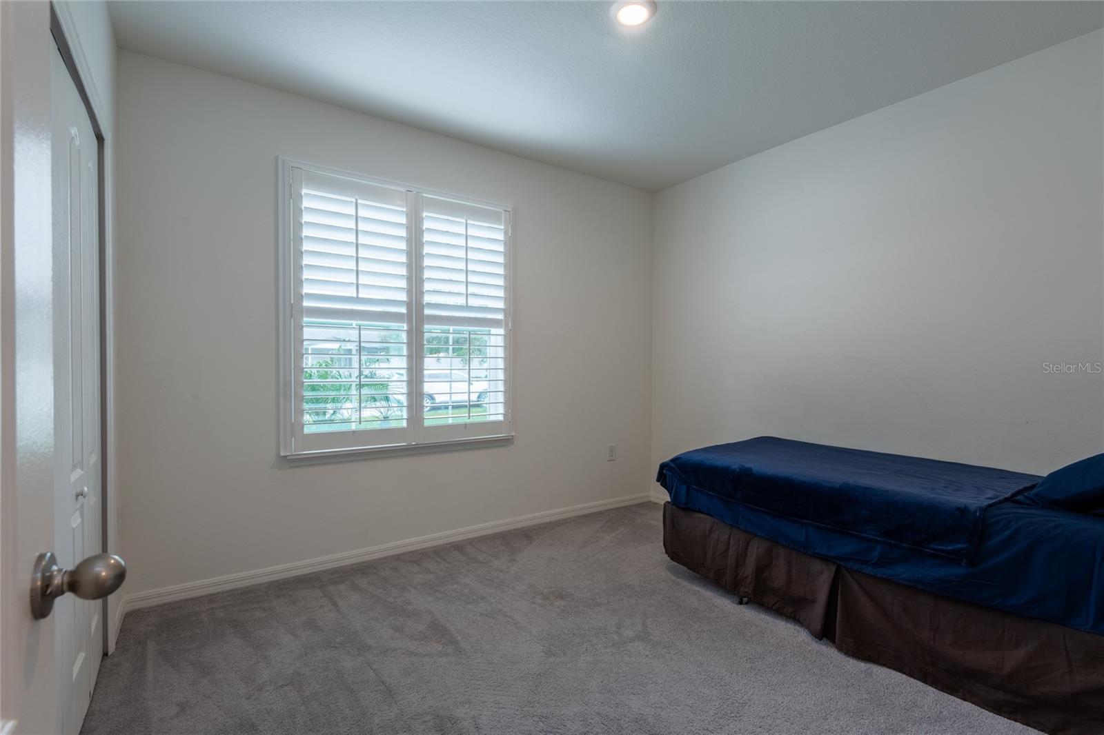 2nd front bedroom with plantation shutters.