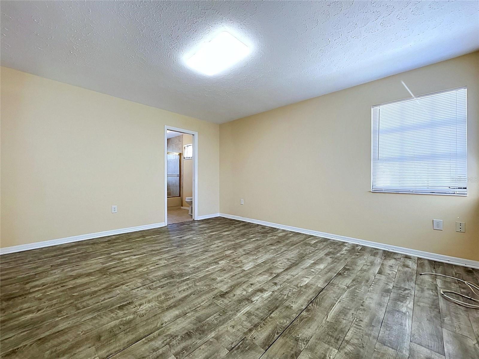main floor bedroom with bathroom and laundry