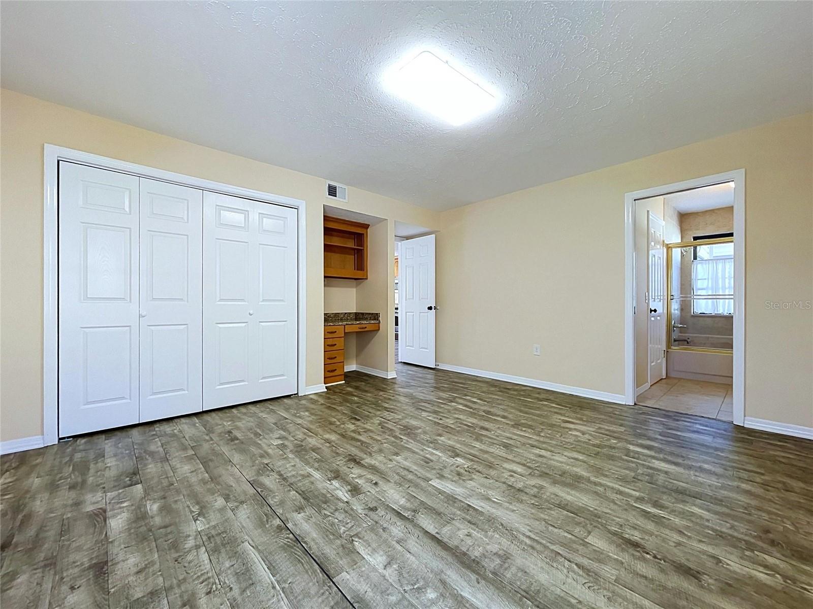 main floor bedroom with bathroom and laundry access