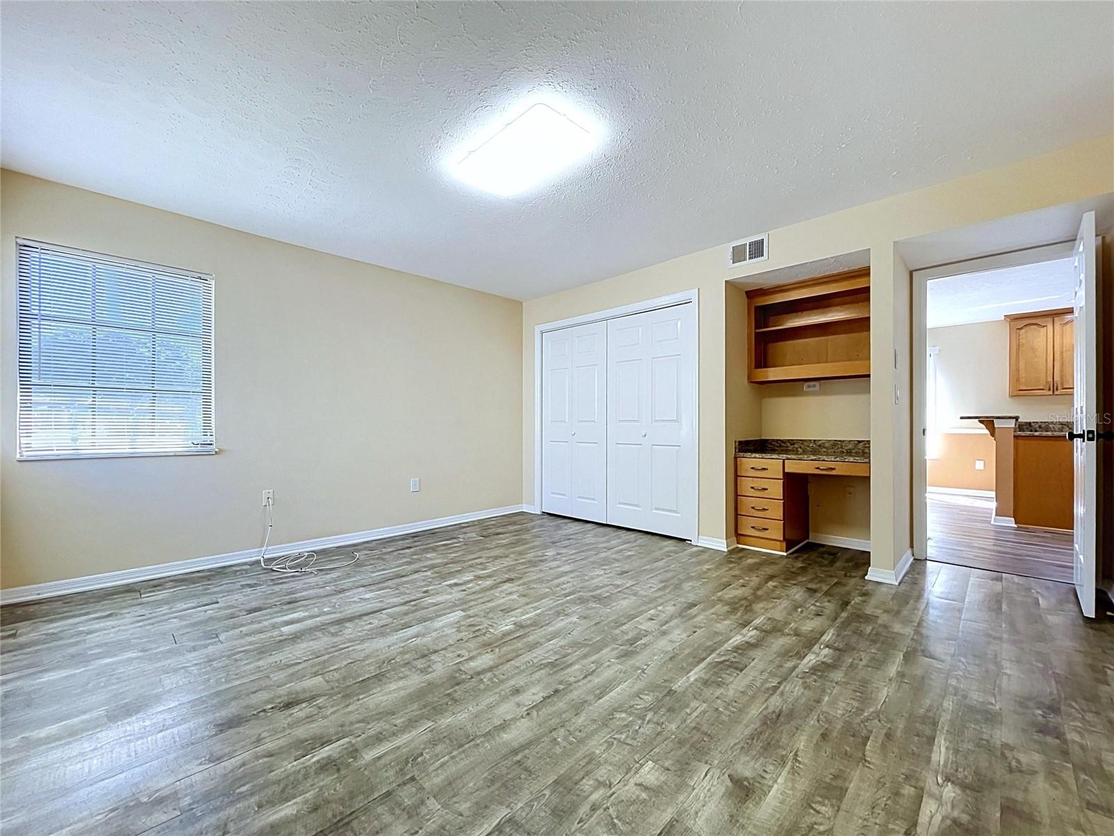 main floor bedroom with bathroom and laundry
