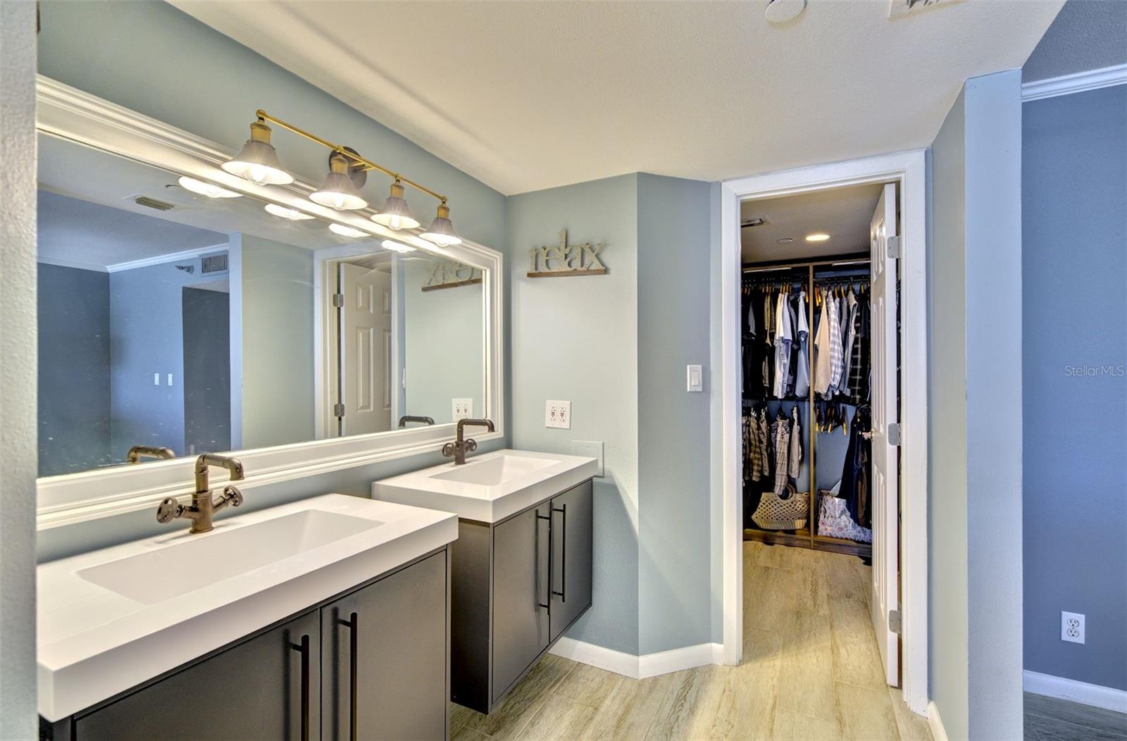 Primary bathroom dual vanities with walk in closet