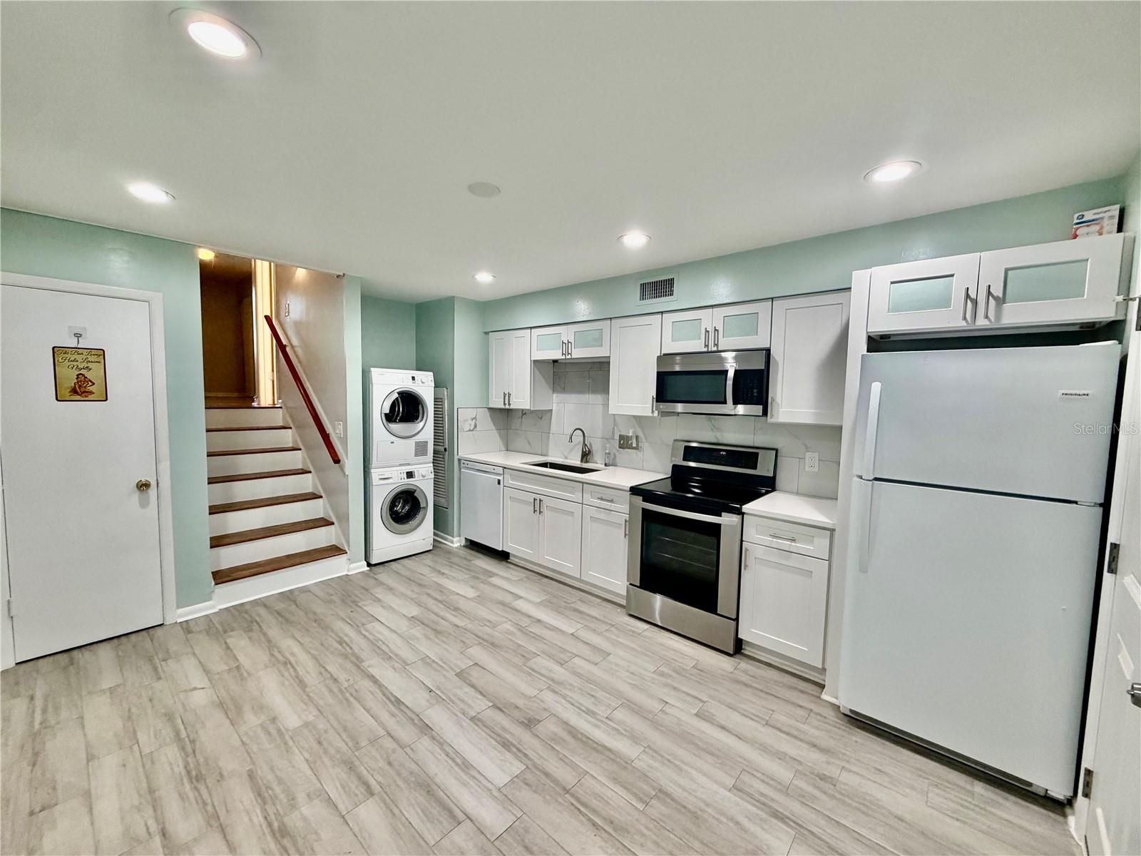 The kitchen is the first room when you enter from the backside. It is on the first level.