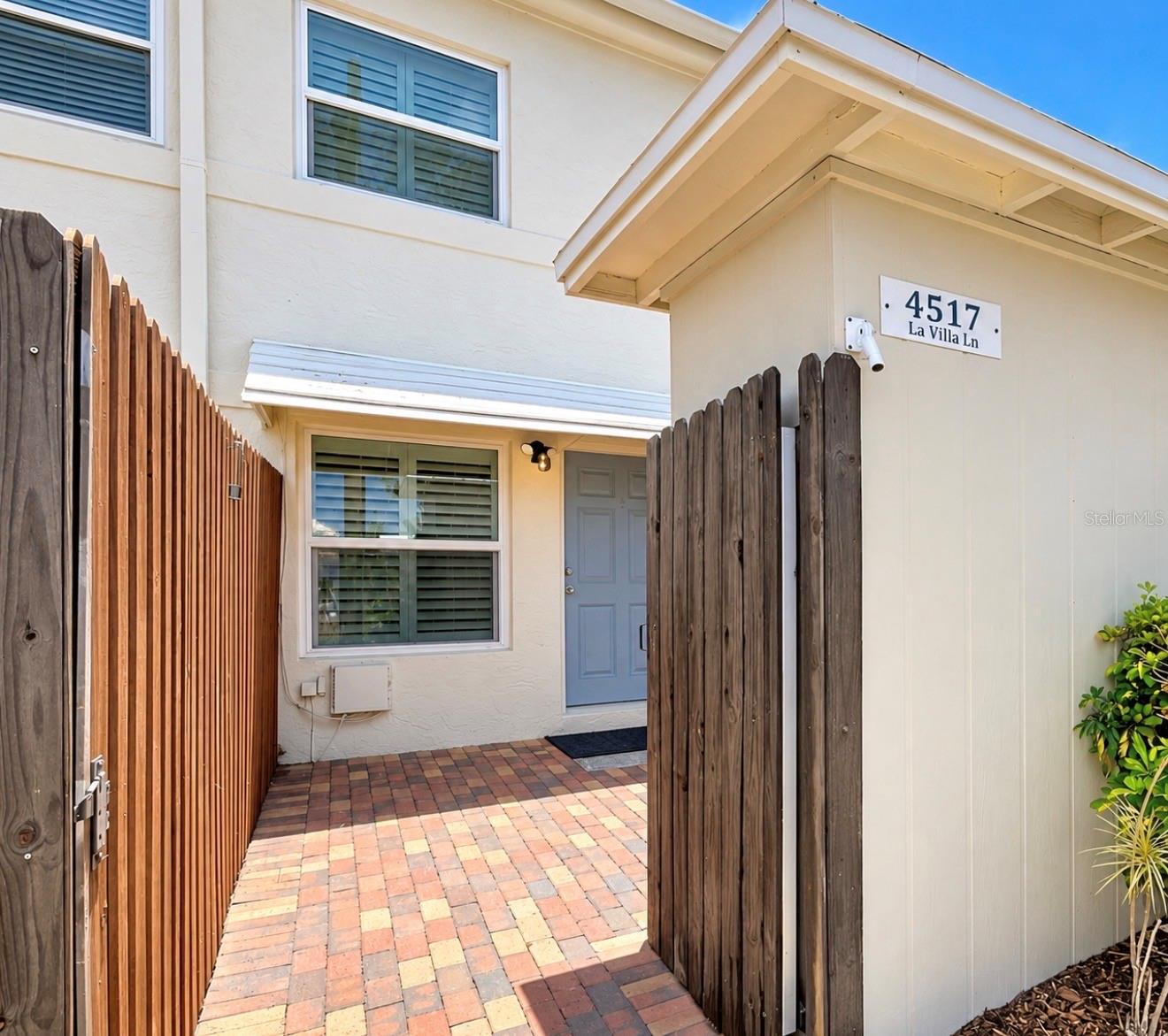 This is the entrance from the backside, where the parking spot is. You have a private patio area and storage area. This is the entrance from the backside, where the parking spot is. You have a private patio area and storage area.