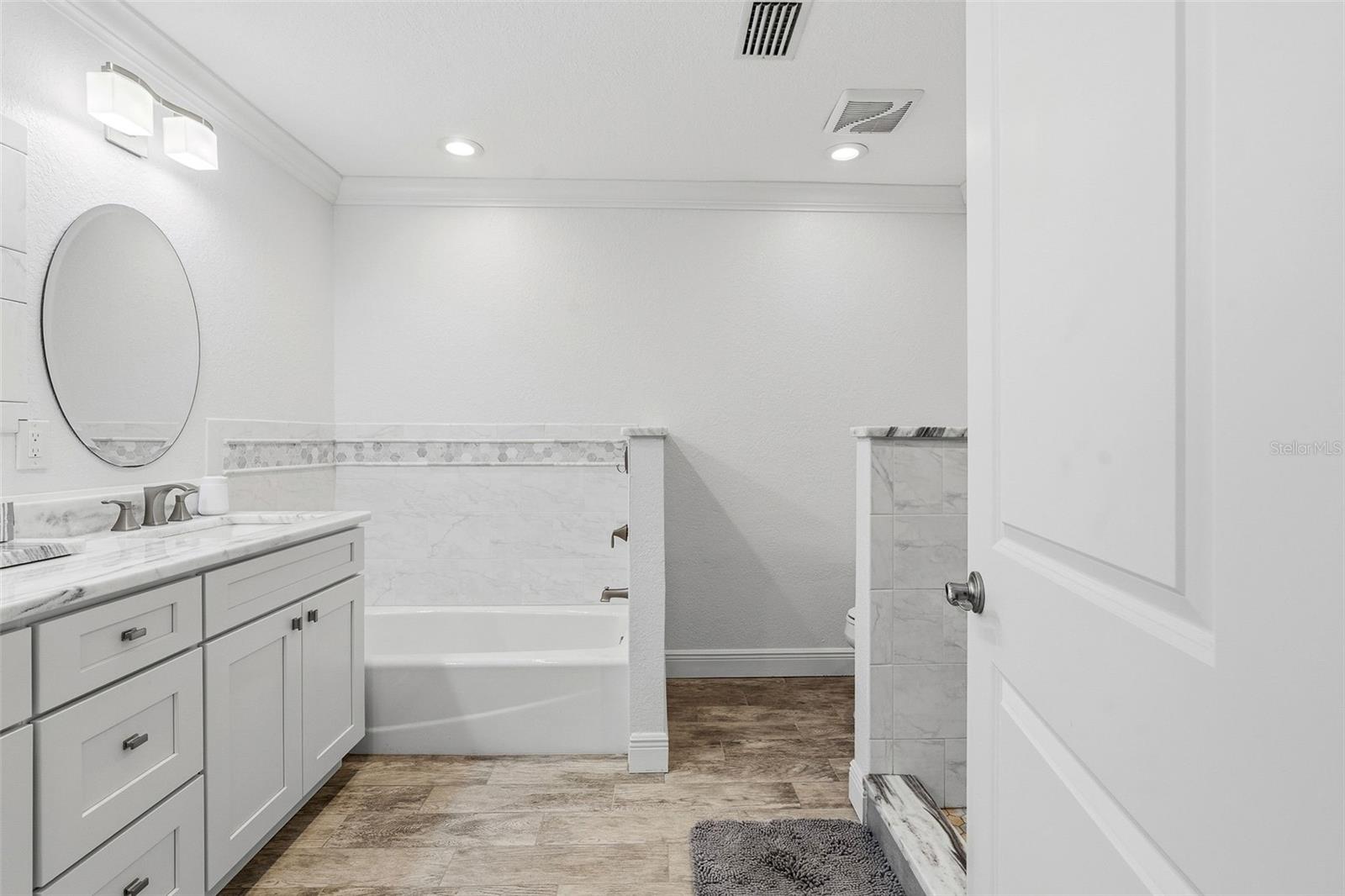 Primary ensuite with tub and separate walk-in shower.