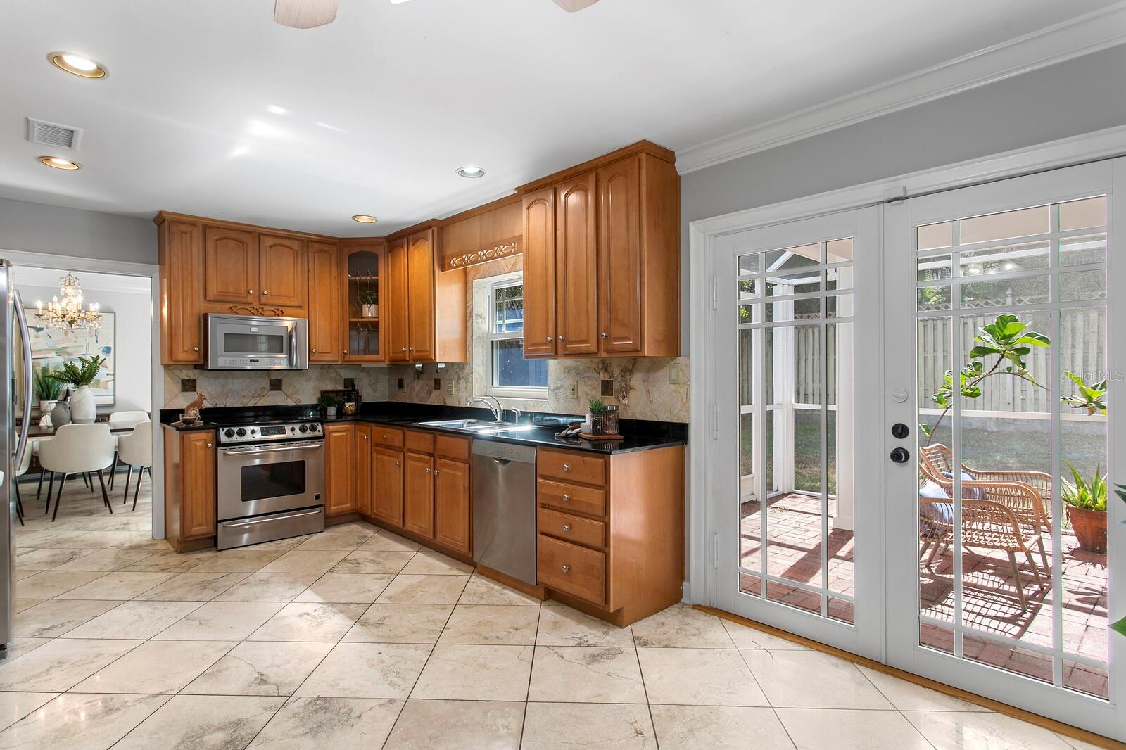 The closed lanai is just to the right of the kitchen and you can see the formal dining room.