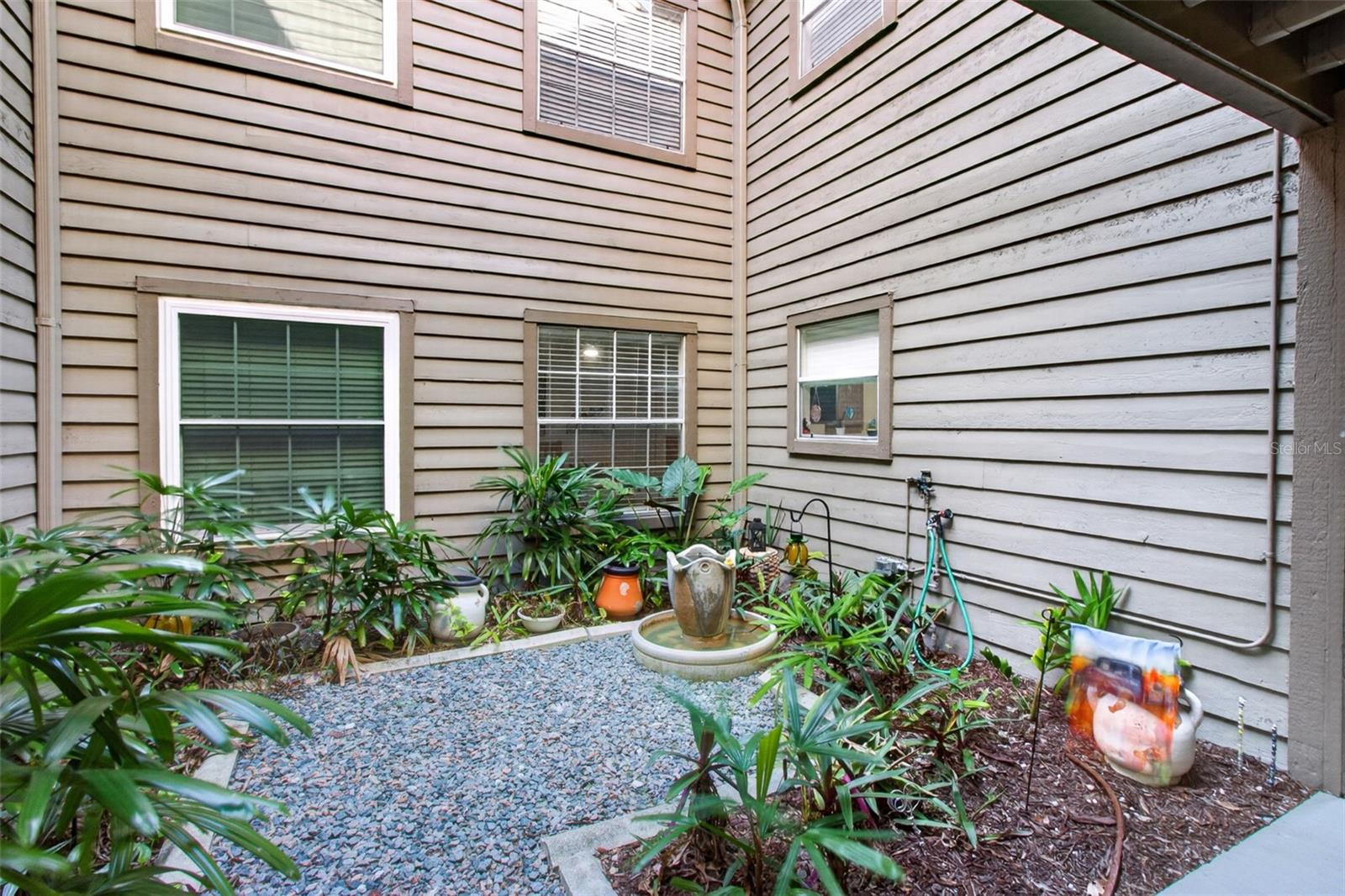 Courtyard just before front door. Kitchen window & bedroom 2 face this.