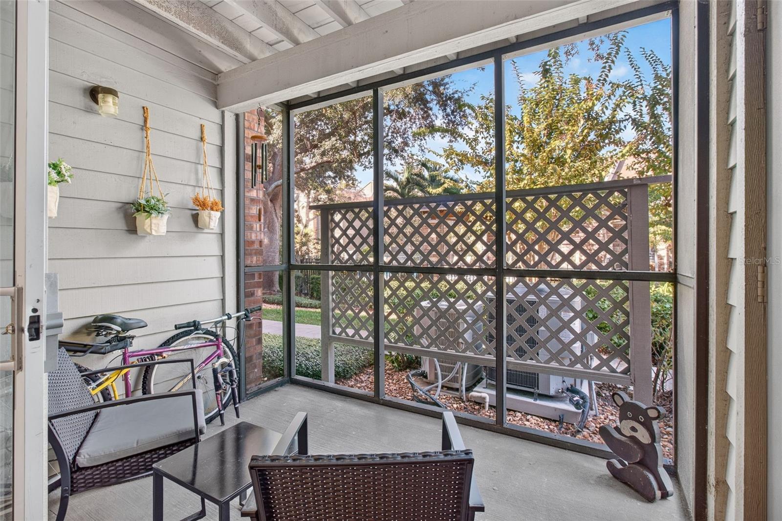 Rear screened-in porch facing north, pool view