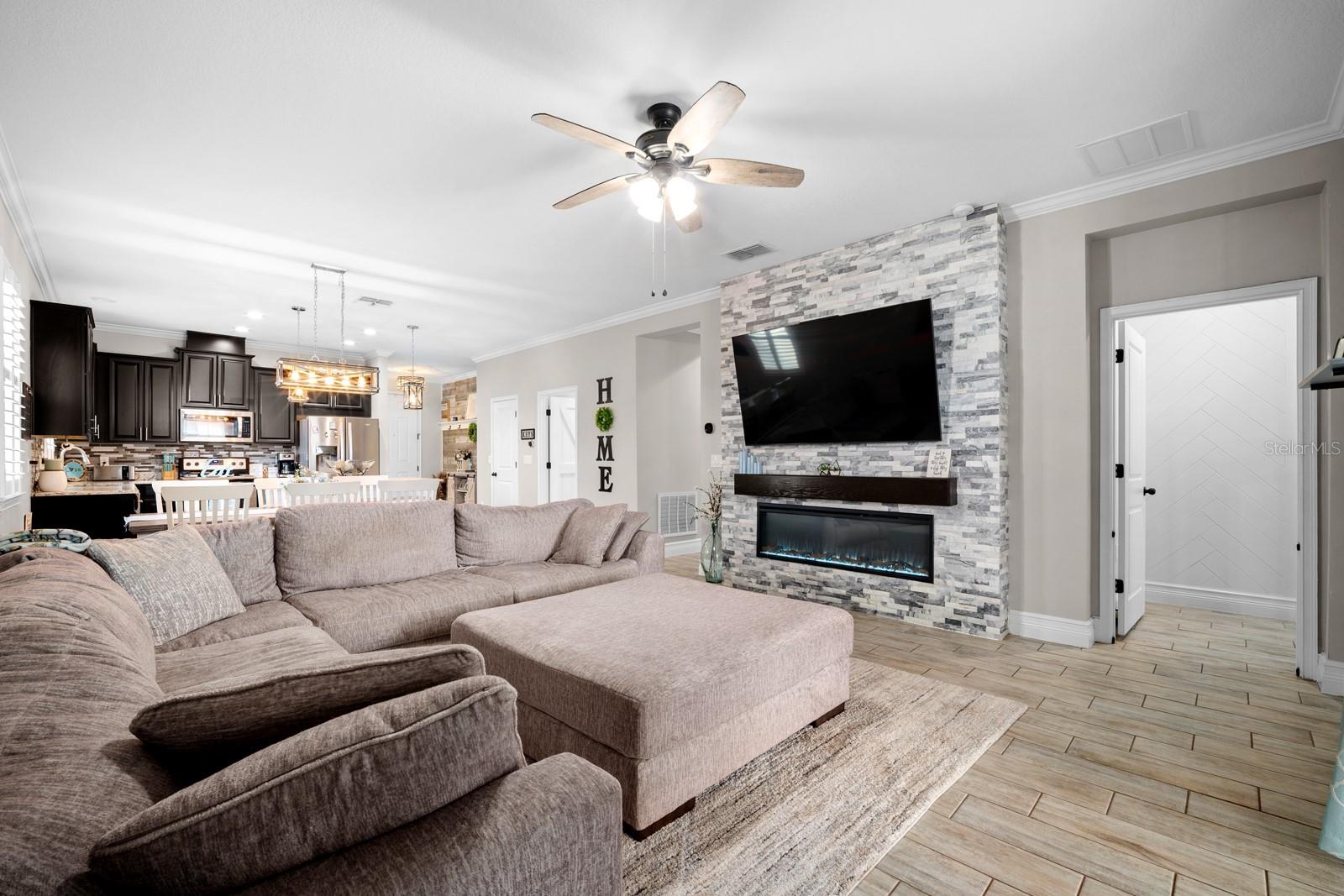 Family room with stacked stone fireplace wall and built-in TV space