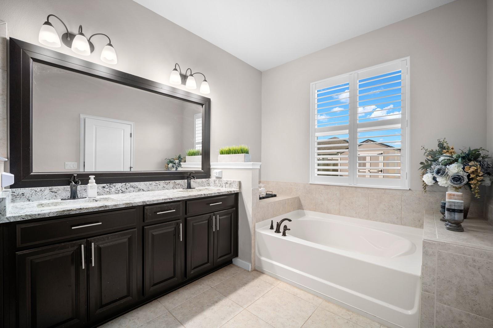 Primary bath with dual sinks, granite vanity and soaking tub