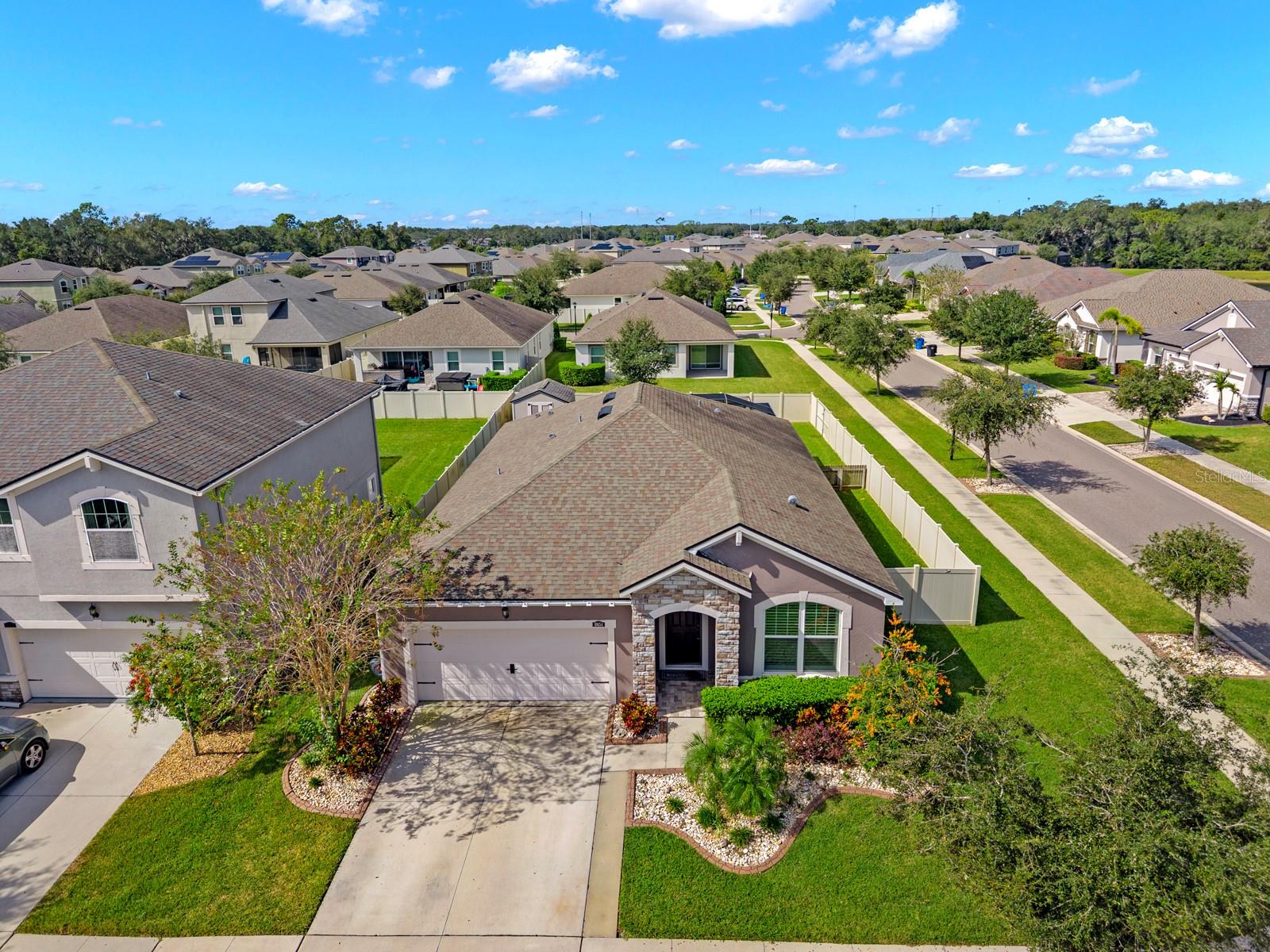 Aerial view of the front of the home and the surrounding neighborhood