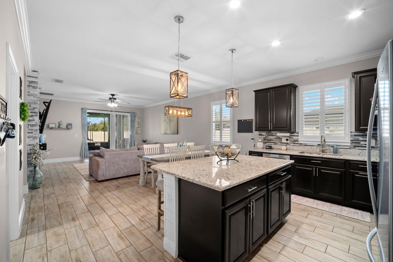 Kitchen island overlooking the open family room and sliders to the lanai