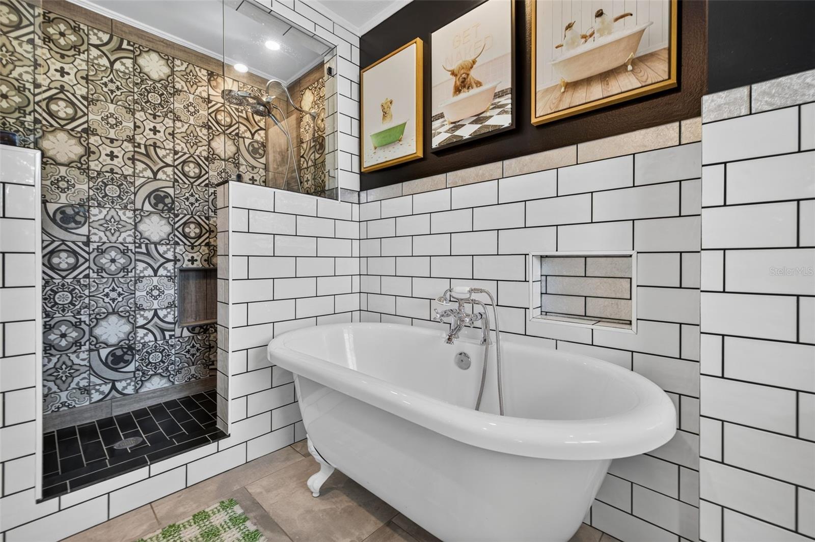 Primary bathroom with stand alone clawfoot tub, double shower head walk in shower, and double sink vanity