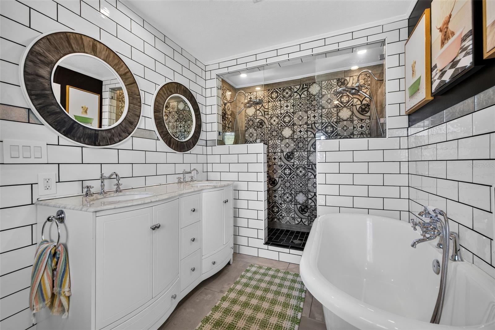Primary bathroom with stand alone clawfoot tub, double shower head walk in shower, and double sink vanity
