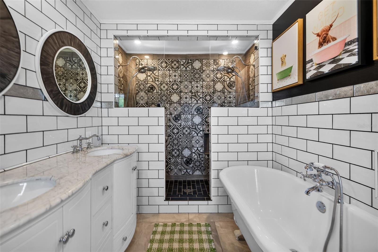 Primary bathroom with stand alone clawfoot tub, double shower head walk in shower, and double sink vanity