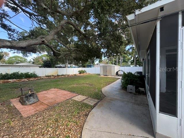 West side view of backyard and storage shed