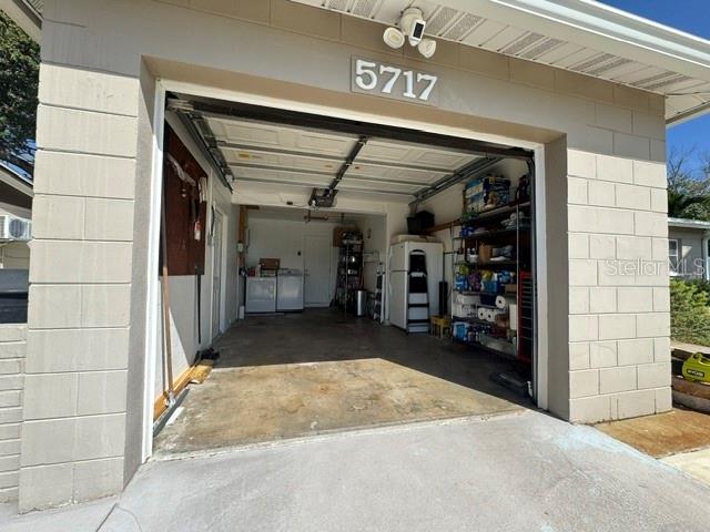 Oversized one car garage with storage area to the right of the