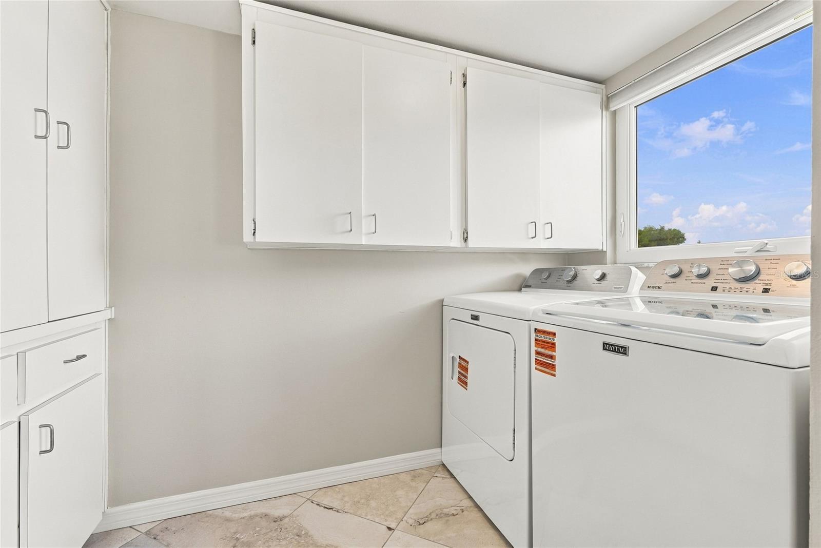 Inside laundry room with loads of storage cabinets
