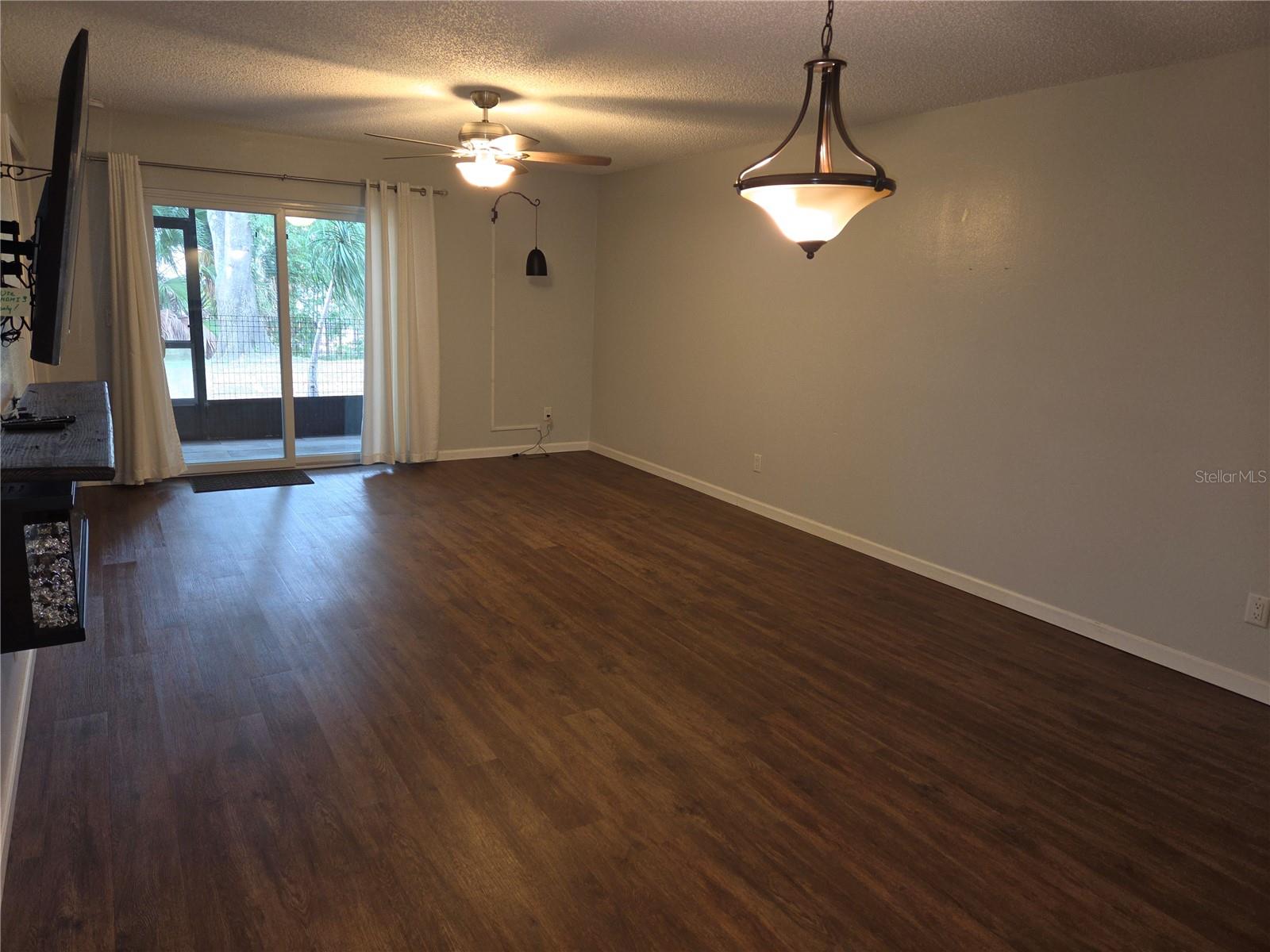 Living room with impact sliding door to the screened porch