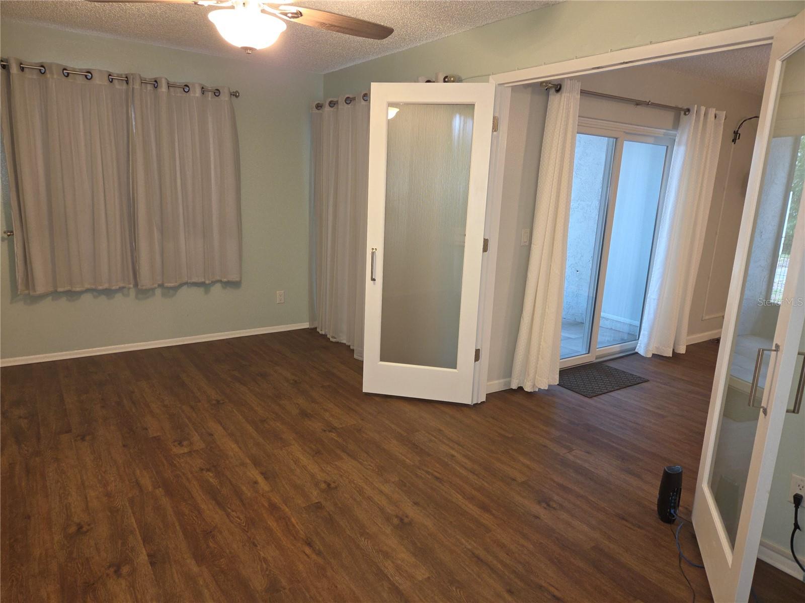 Primary bedroom has a French door entrance from the living room.
