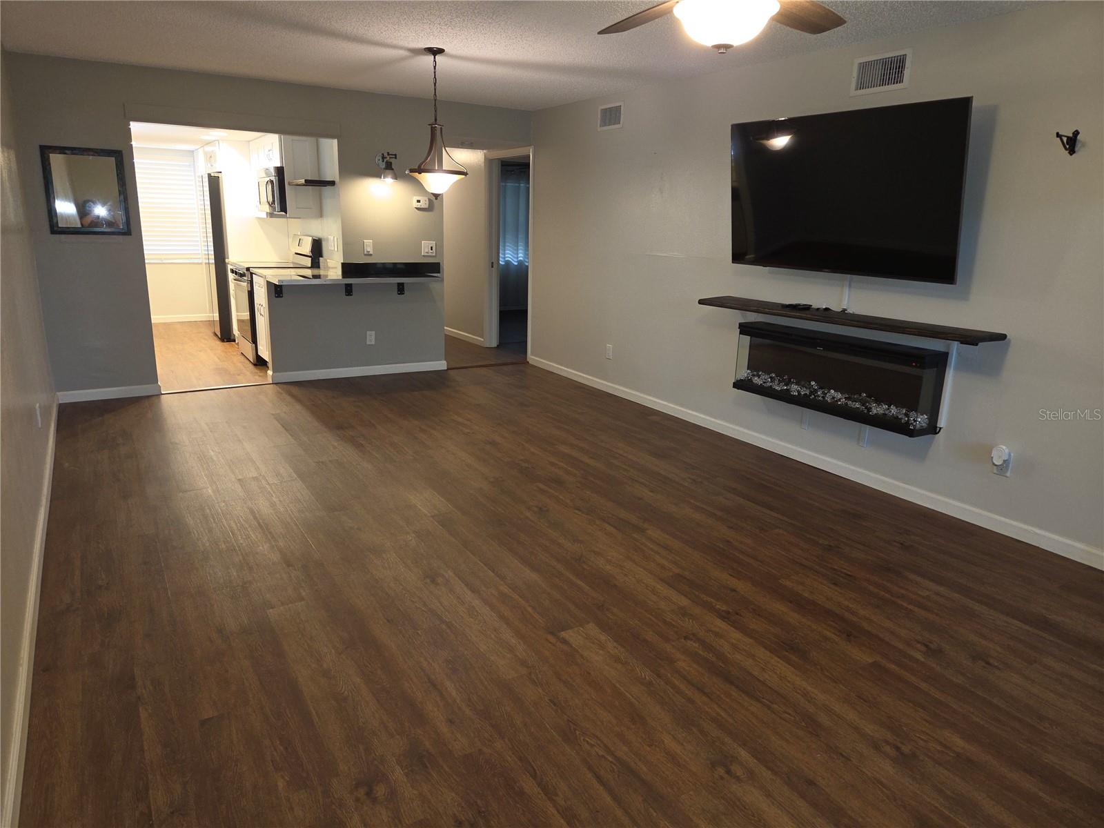 Living/dining combination features eat-at bar and access to updated kitchen