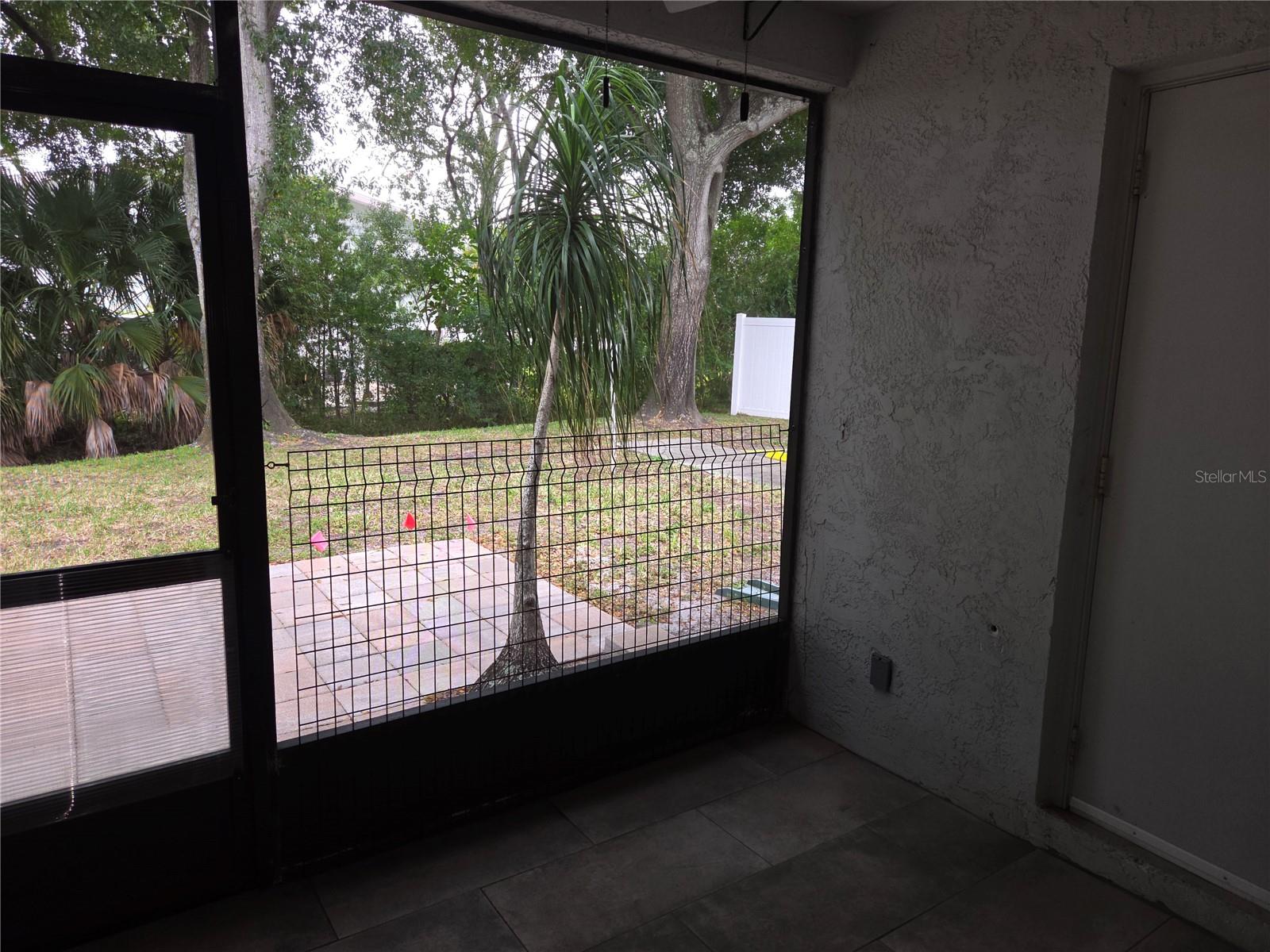 Screened porch with utility closet and pavered patio