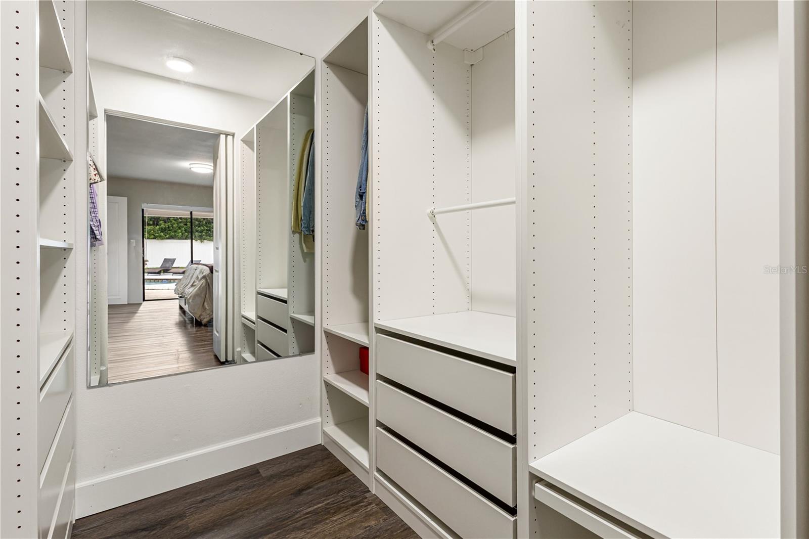 PRIMARY WALK IN CLOSET WITH BUILT INS