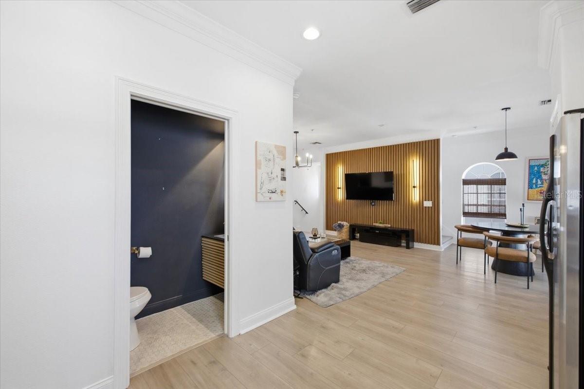 View from Kitchen into Living Room, half bath on main living floor.