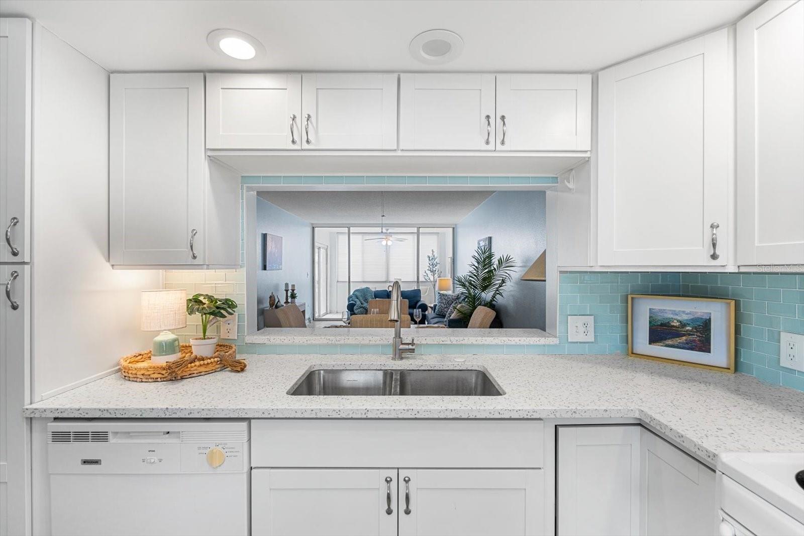Thoughtfully updated kitchen offers quartz countertops and views of the great room.
