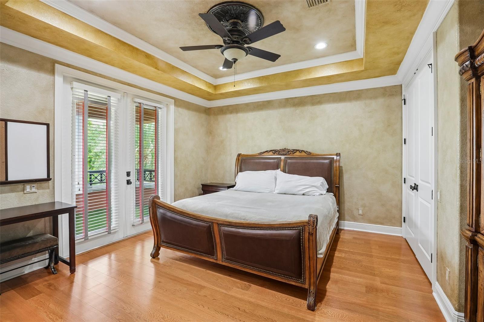 Upstairs bedroom with en-suite bath and balcony access.