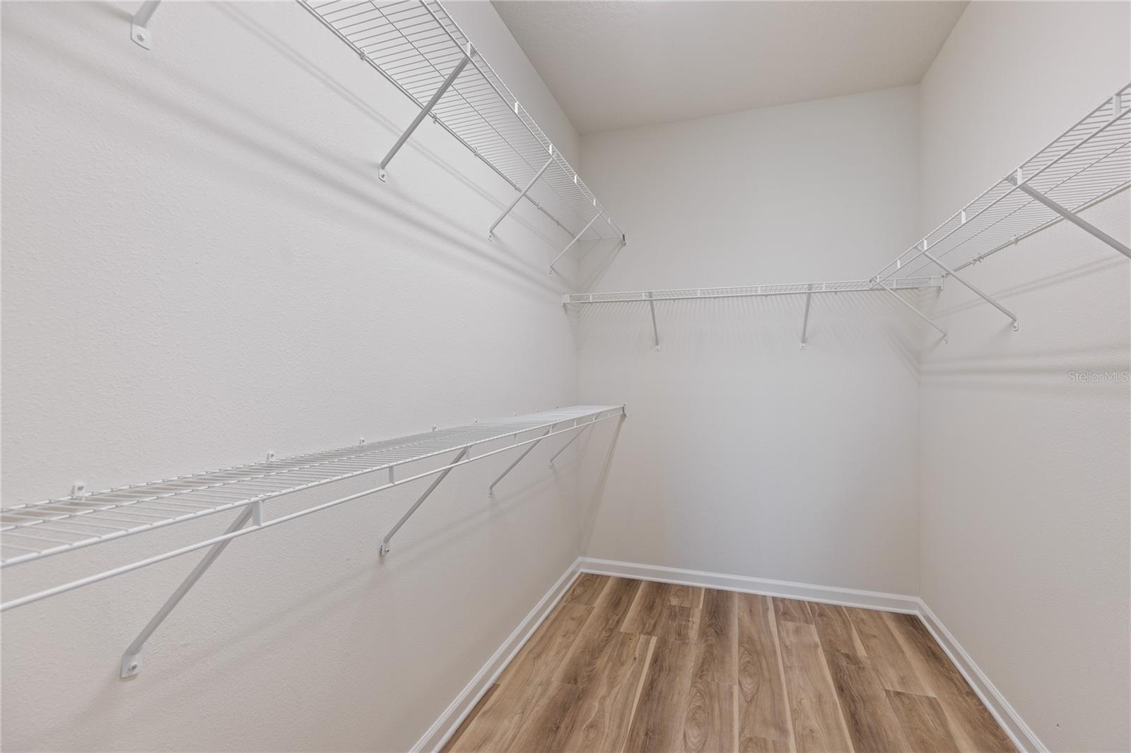 Primary bedroom walk in closet 1