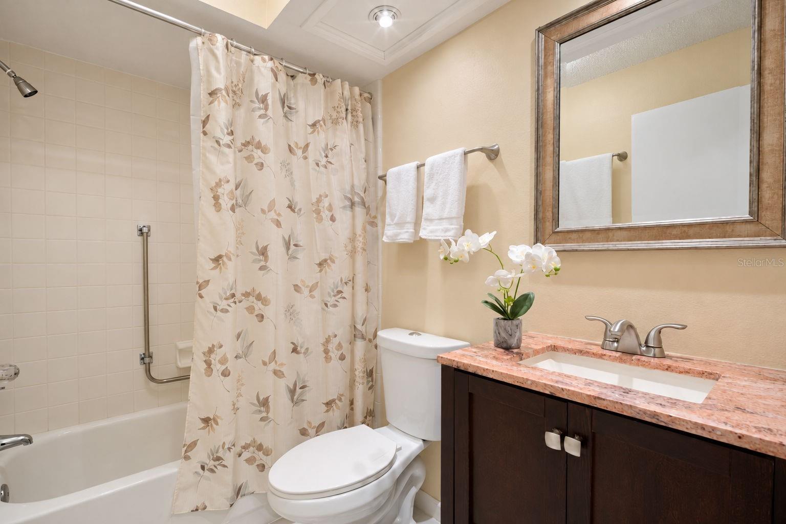 Updated hall bath is tucked between the main living & guest suite~