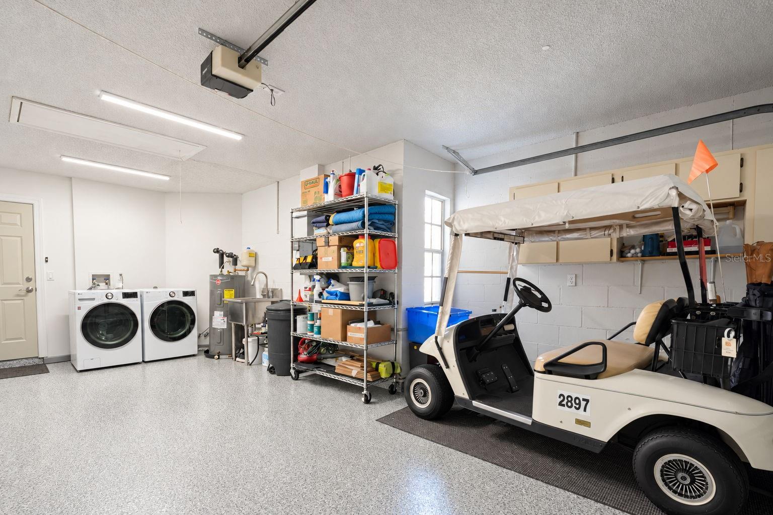 1.5 car garage with beautifully epoxyed flooring, and newer 2024 "smart" washer/dry, & convenient utility sink~