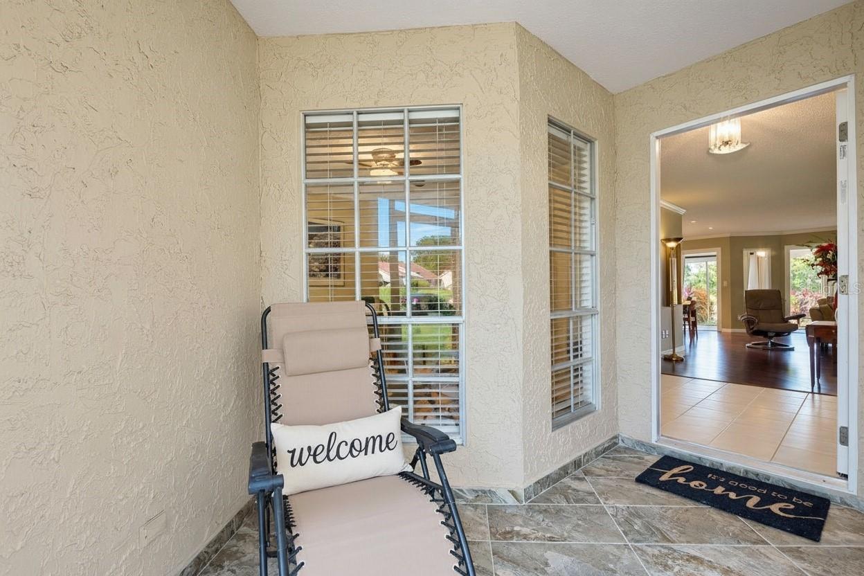 Welcoming front screened porch entry with beautiful tiled flooring~