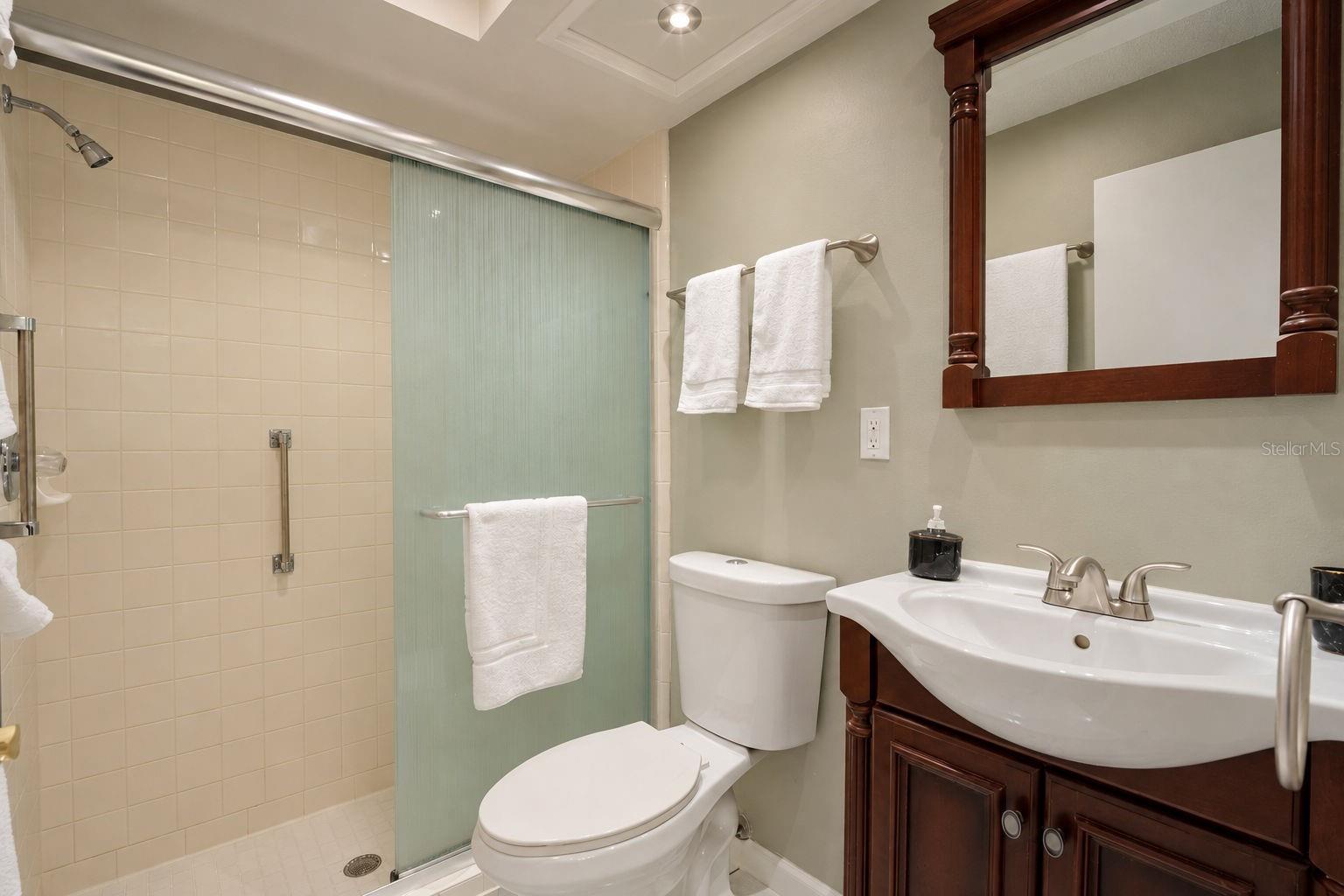Private en-suite bath and glass enclosed walk-in shower~