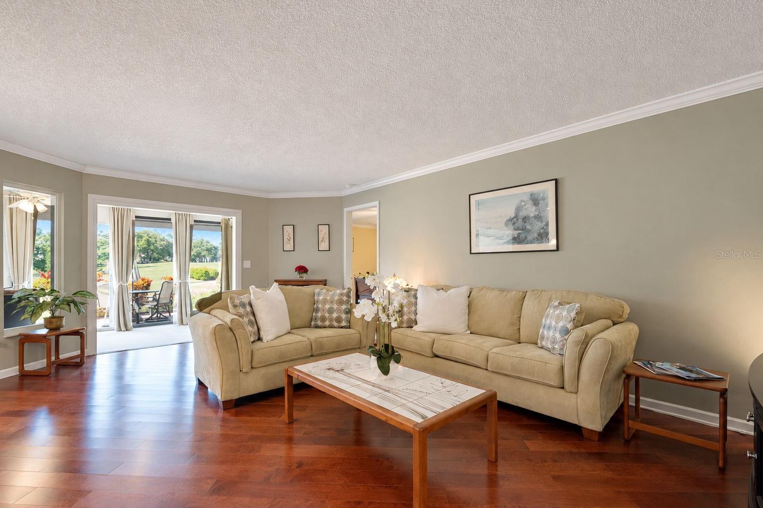Beautiful hardwood flooring in the living/dining room combo & elegant crown molding throughout~