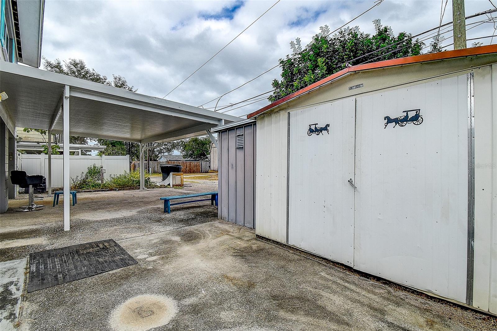 Rear Carport With 2 Storage Sheds