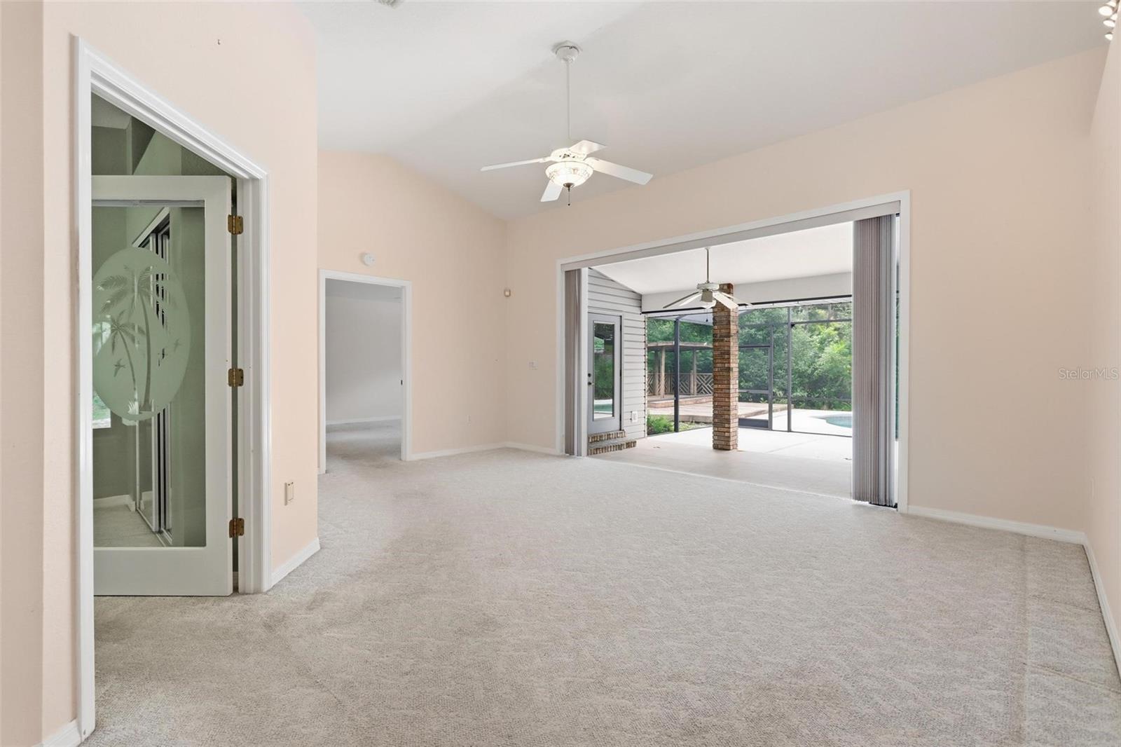 Sliding fully opened onto back patio.  Office/bedroom #3 on right, primary straight ahead.