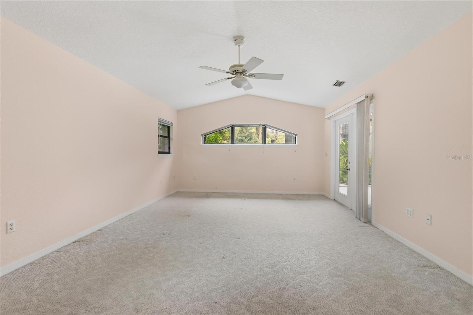 Primary bedroom with sliders to patio.