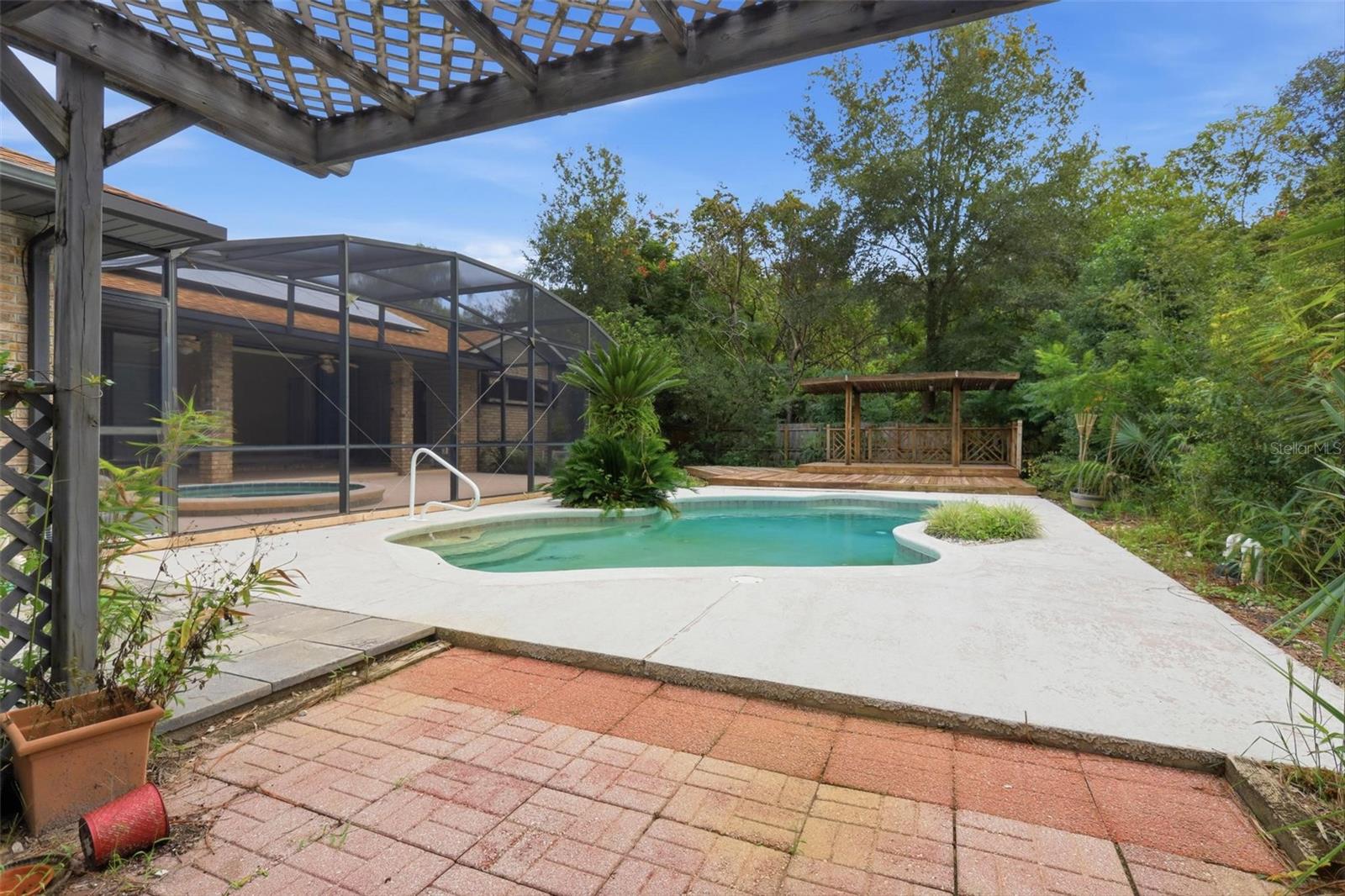 From BBQ/potting shed looking east to pool and covered deck.