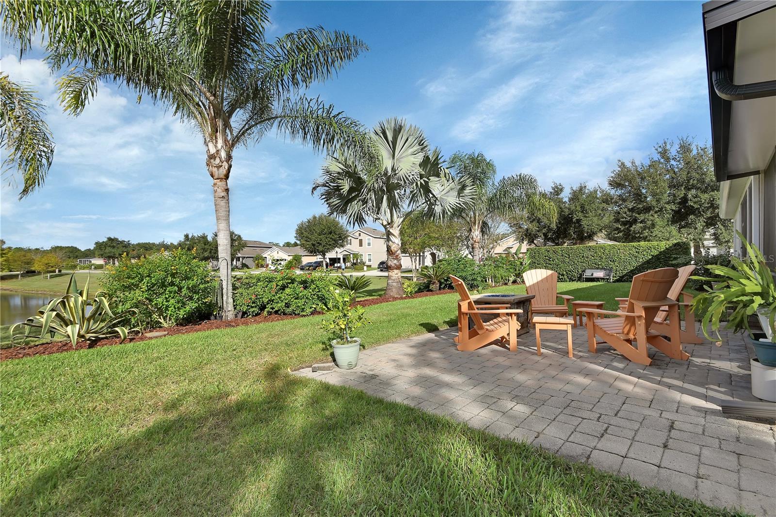 Paver patio with water and garden view
