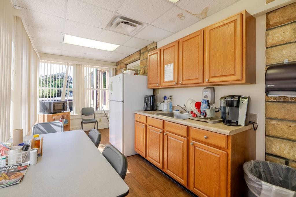 First floor kitchen with wrap around windows and exterior access.