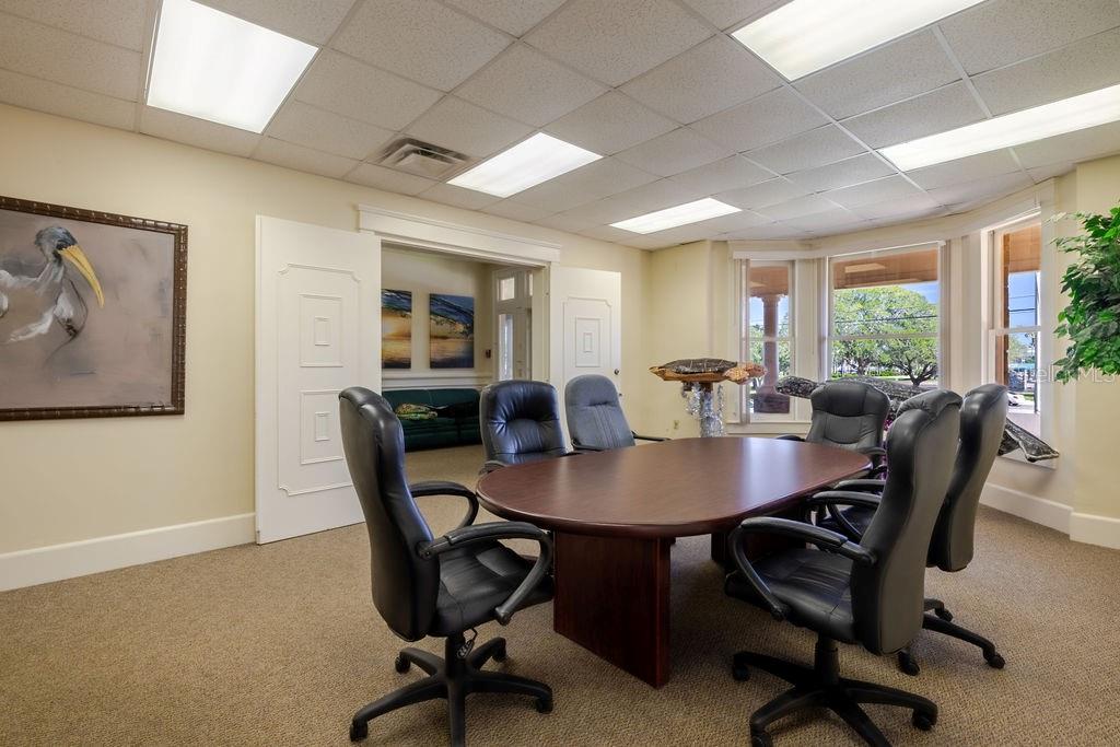 Conference room and previous living area with beautiful bay window views spanning the Halifax Harbor Marina & Park.