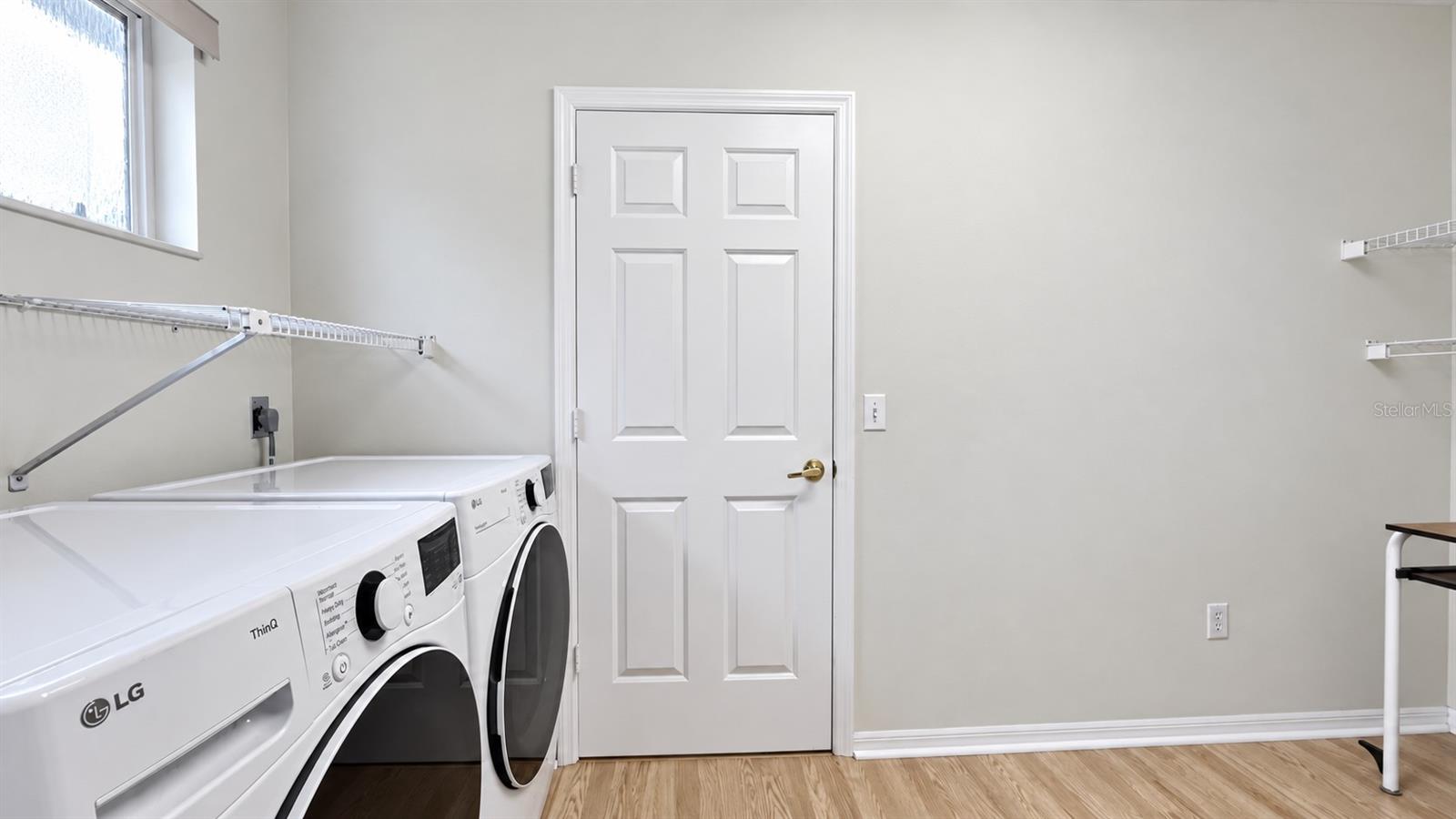 Large laundry room with tons of storage possibilities.