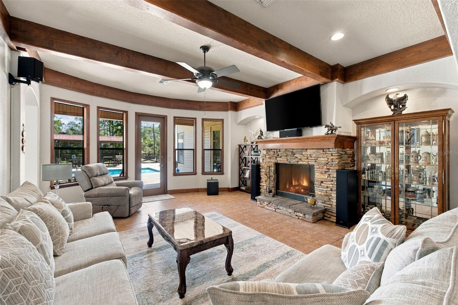 FAMILY ROOM WITH WOOD BEAM CEILING AND GAS FIREPLACE
