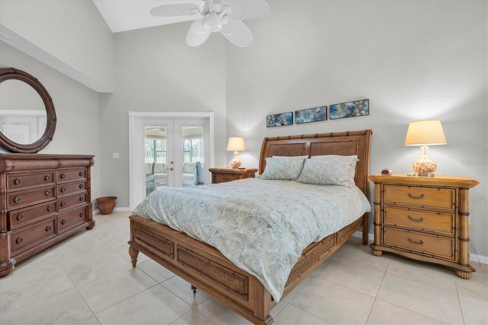 owners suite with high ceilings and access to Florida room