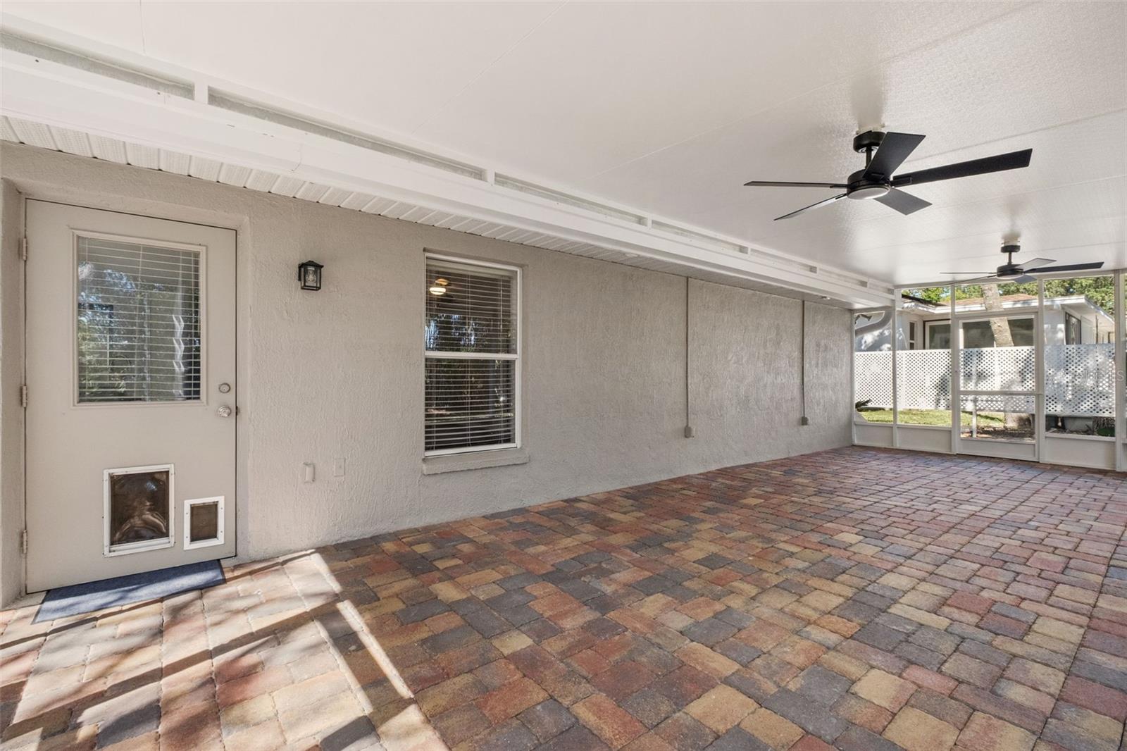 Expansive Screened Rear Porch with Pavers